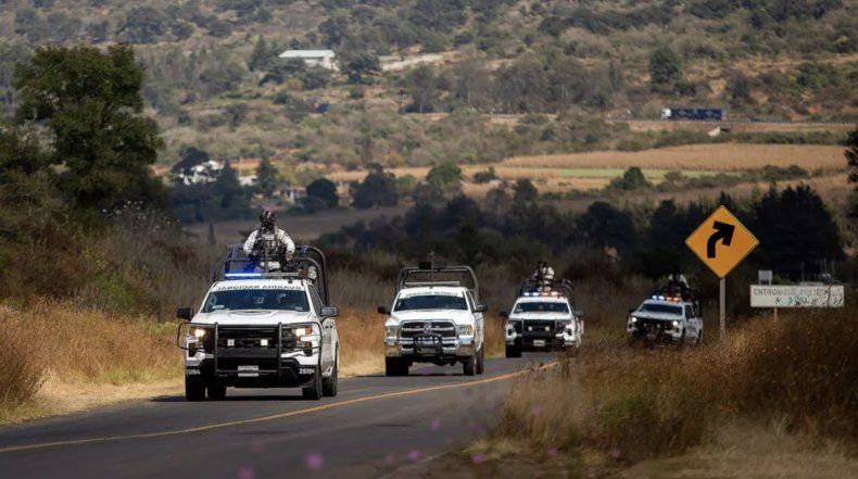 La Guardia Nacional de México patrulla un área donde unos presuntos miembros del crimen organizado quemaron unos vehículos, en una autopista cerca de Quiroga, en el estado de Michoacán, el 17 de noviembre de 2025.