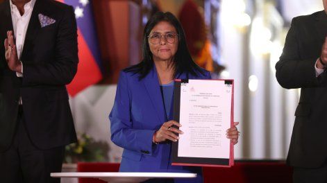 La presidenta encargada de Venezuela, Delcy Rodríguez, sostiene el documento de la ley de amnistía, en Caracas.