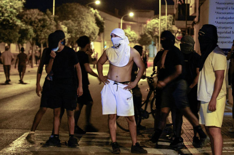 Personas encapuchadas se reúnen en las calles de Torre Pacheco el 14 de julio, tras tres noches consecutivas de disturbios
