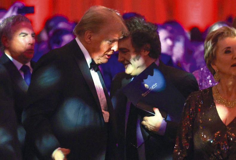 Donald Trump conversa con Javier Milei durante un evento en Florida, noviembre 2024.