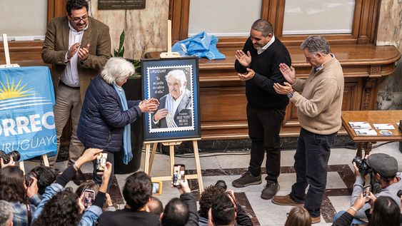 Lucía Topolansky, secretario de Presidencia Alejandro Sánchez, presidente del Correo Gabriel Bonfrisco y presidente de la República Yamandú Orsi descubren una gigantografía del sello de José Mujica. Lucía Topolansky, secretario de Presidencia Alejandro Sánchez, presidente del Correo Gabriel Bonfrisco y presidente de la República Yamandú Orsi descubren una gigantografía del sello de José Mujica.