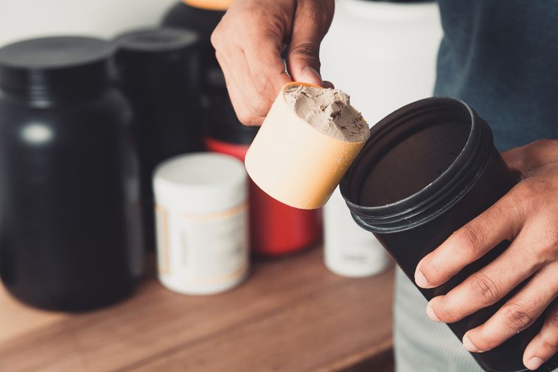 hands-holding-scoop-whey-protein-shaker-with-copy-space-healthy-life